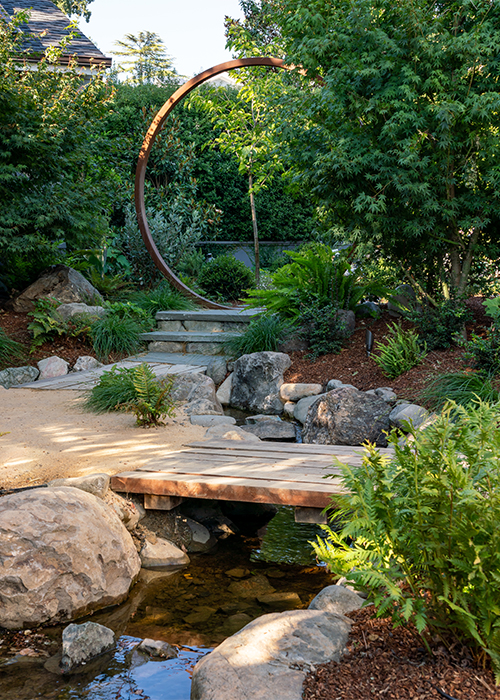 pathway leading to a bridge over a small creek creek