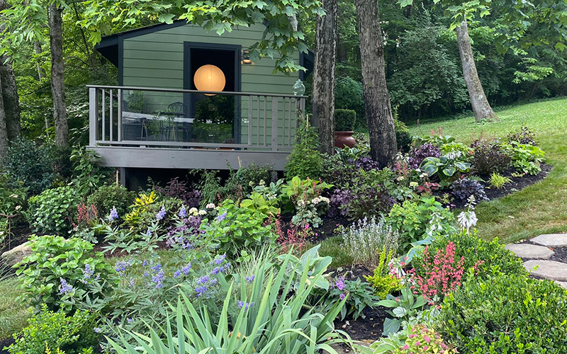 shady landscape with yoga shed in background