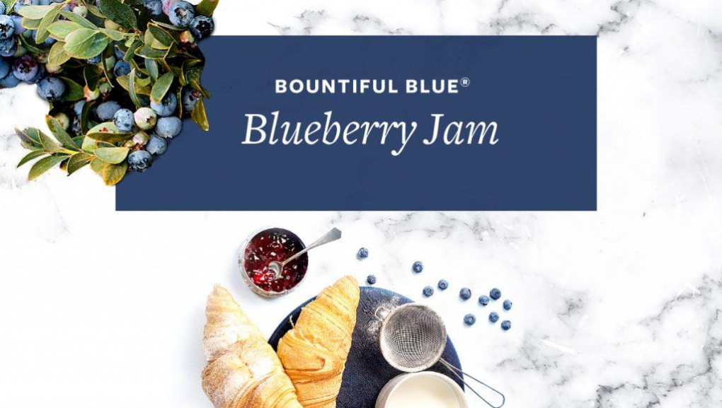 Aerial view of jam on countertop next to plate of croissants with text that says, "Bountiful Blue Blueberry Jam."