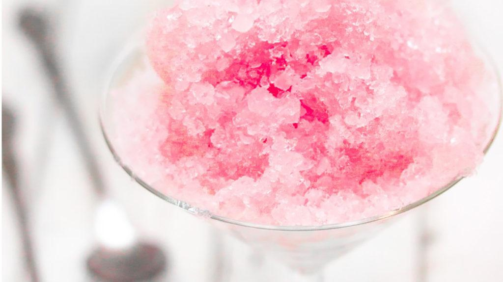 Pink Strawberry Kiwi flavored Shaved Ice in a plastic cup.