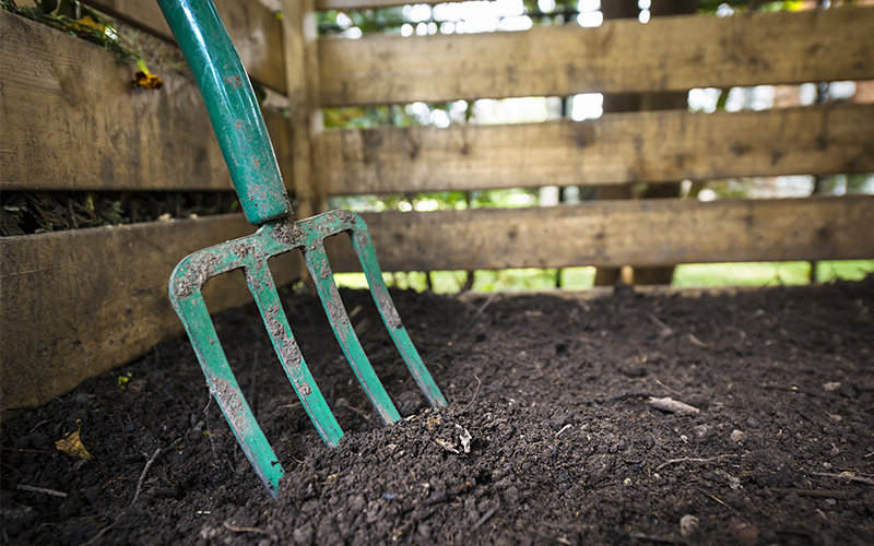 compost with pitch fork